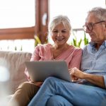 senior couple planning for retirement on a computer at home