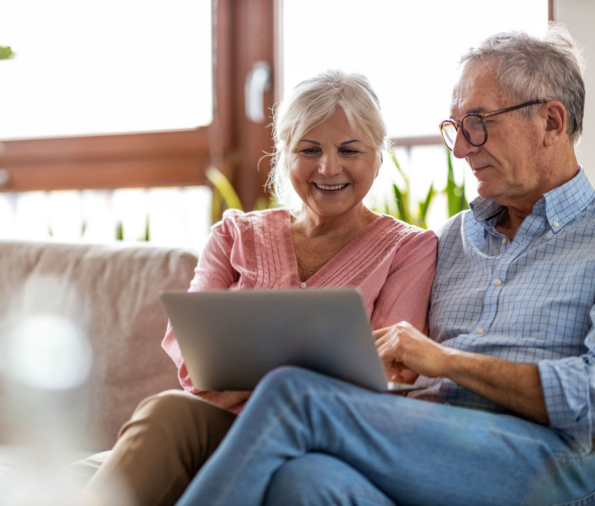 senior couple planning for retirement on a computer at home