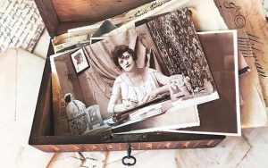a wooden memory box filled with old photos