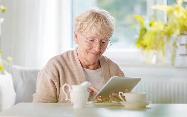 senior woman browsing on her tablet device